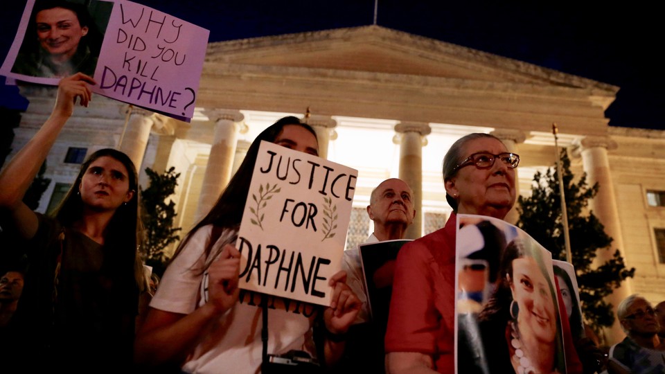 Caruana Galizia's family members protest at Malta's Courts of Justice in August. Signs say "Justice for Daphne" and "Why did you kill Daphne?"