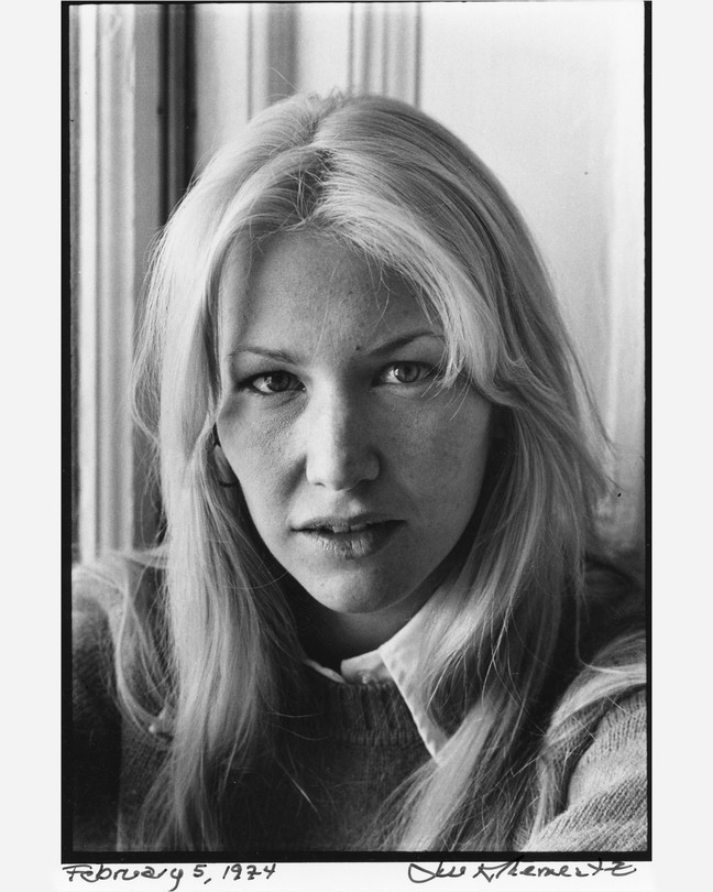 Black and white photo of Annie Dillar sitting near a window