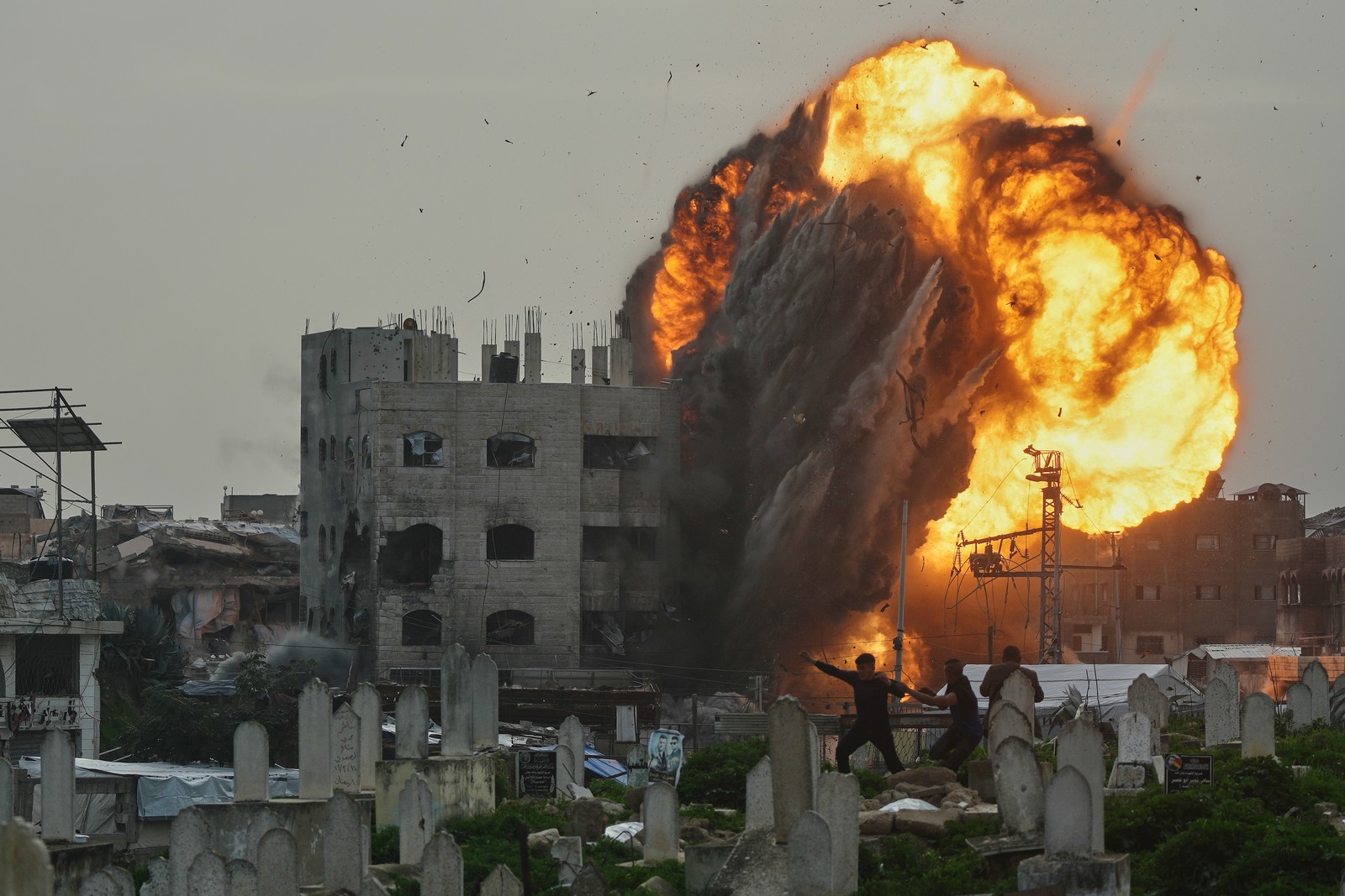Smoke, dust, and flames rise from an Israeli military strike on a building in Gaza.
