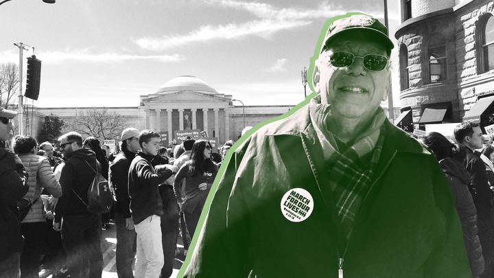A man wearing a "March for Our Lives" pin, surrounded by a crowd in front of the National Gallery of Art