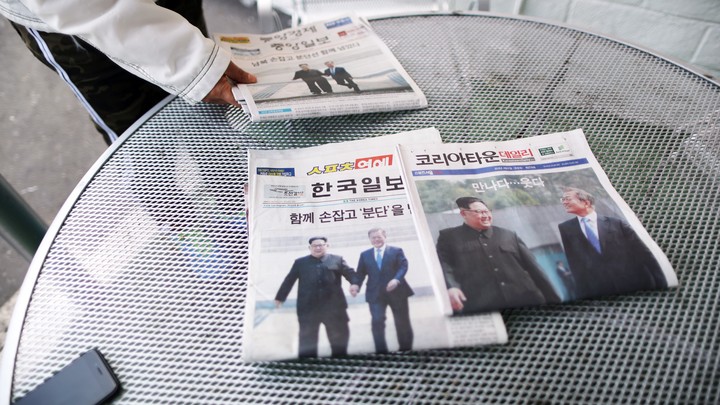 Korean newspapers on a table showing Presidents Kim and Moon together