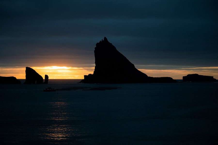 Several small steep islands are seen at sunset.