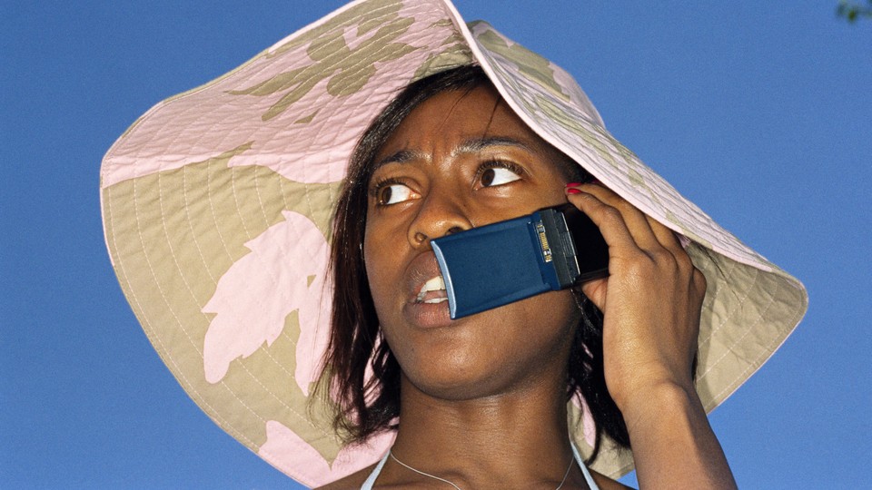 Photograph of a woman on a flip phone