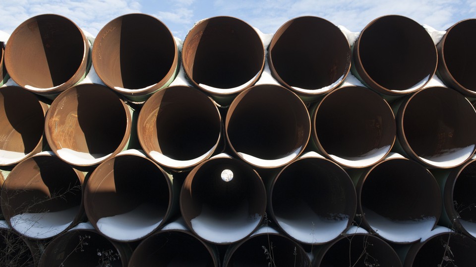 A stack of pipes that have collected snow