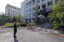 A man takes a photo of ruins in Pripyat, Ukraine.