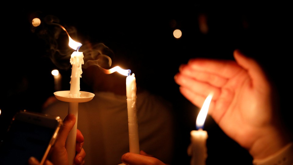 Hands holding candles