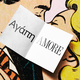 A card with "love" in two different languages sitting atop a comic of two people kissing