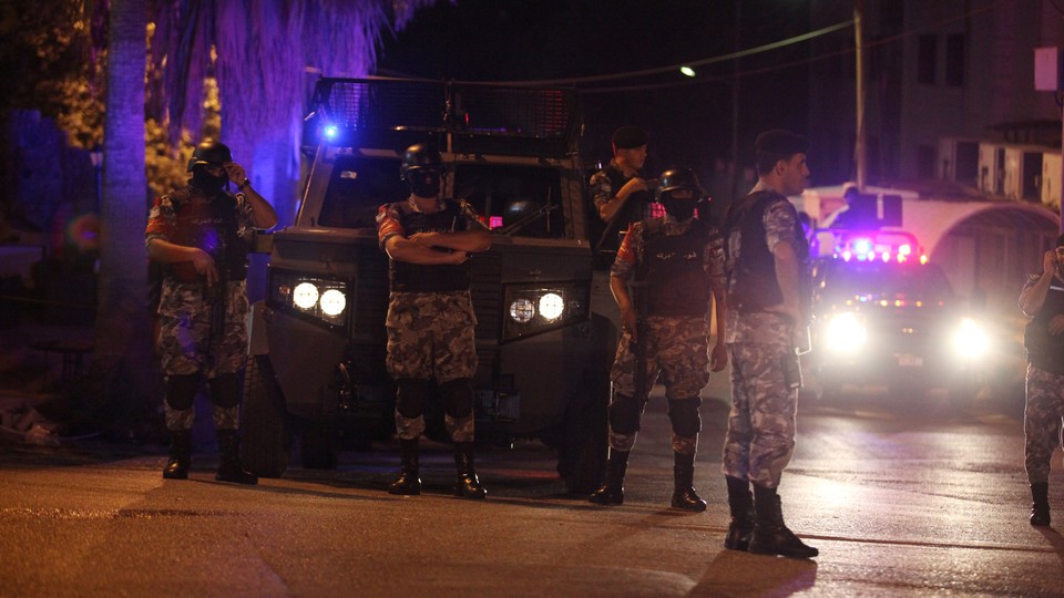 Policemen are seen near the Israeli embassy in Amman.