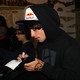 An X-Games athlete signs autographs at the event's Red Bull tent.