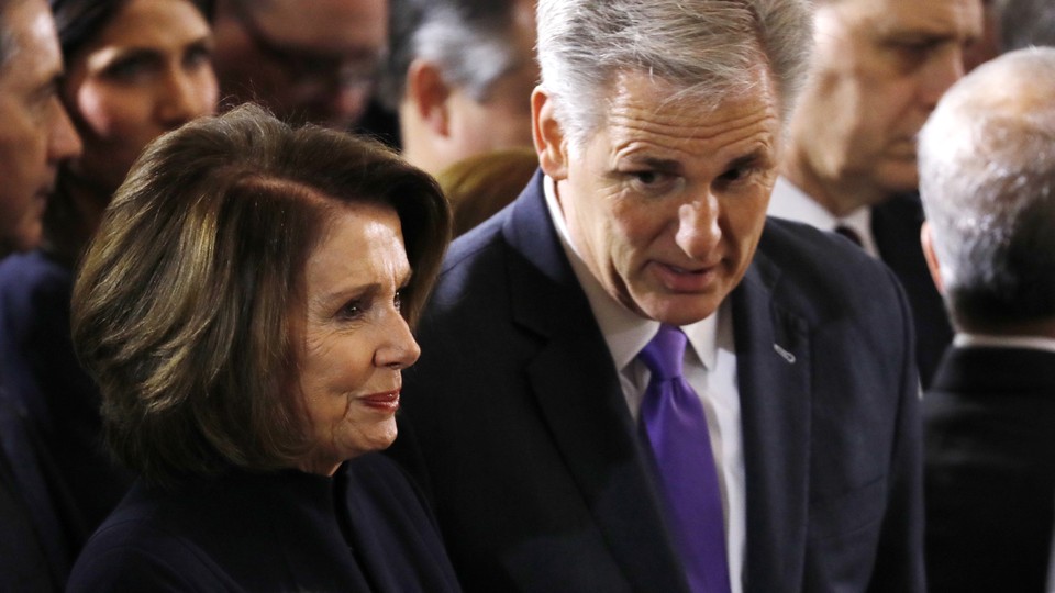 House leaders Nancy Pelosi and Kevin McCarthy speak to one another.