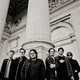 Wilco in monochrome next to large columns