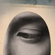 Collage of a woman's eye looking downward on a background of hazy sky