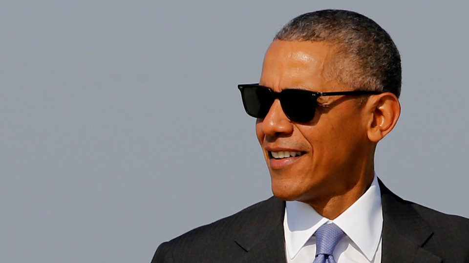 Barack Obama wearing a suit and sunglasses