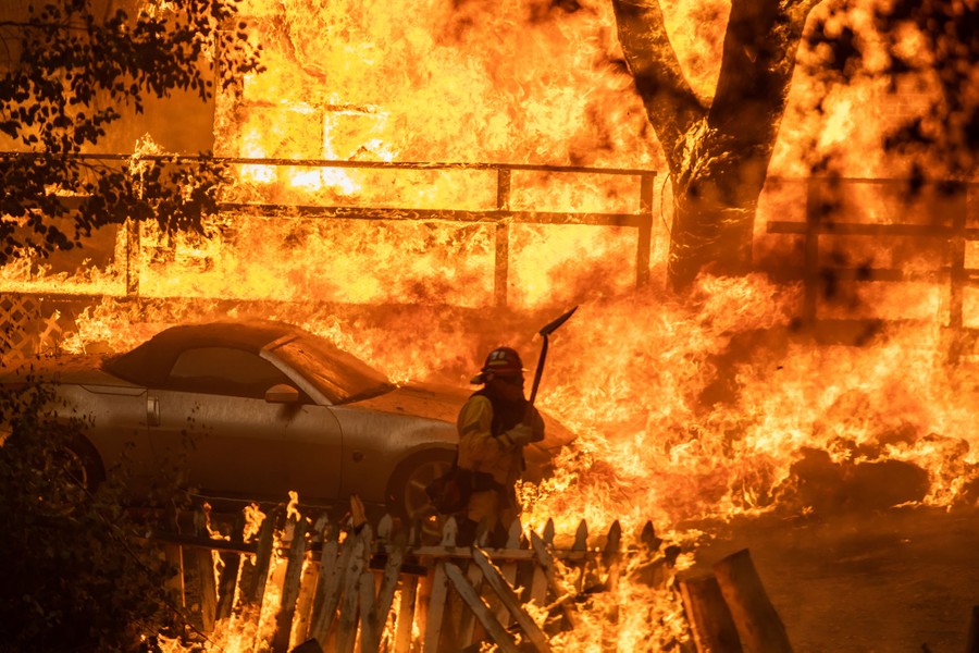 A firefighter surrounded by immense flames