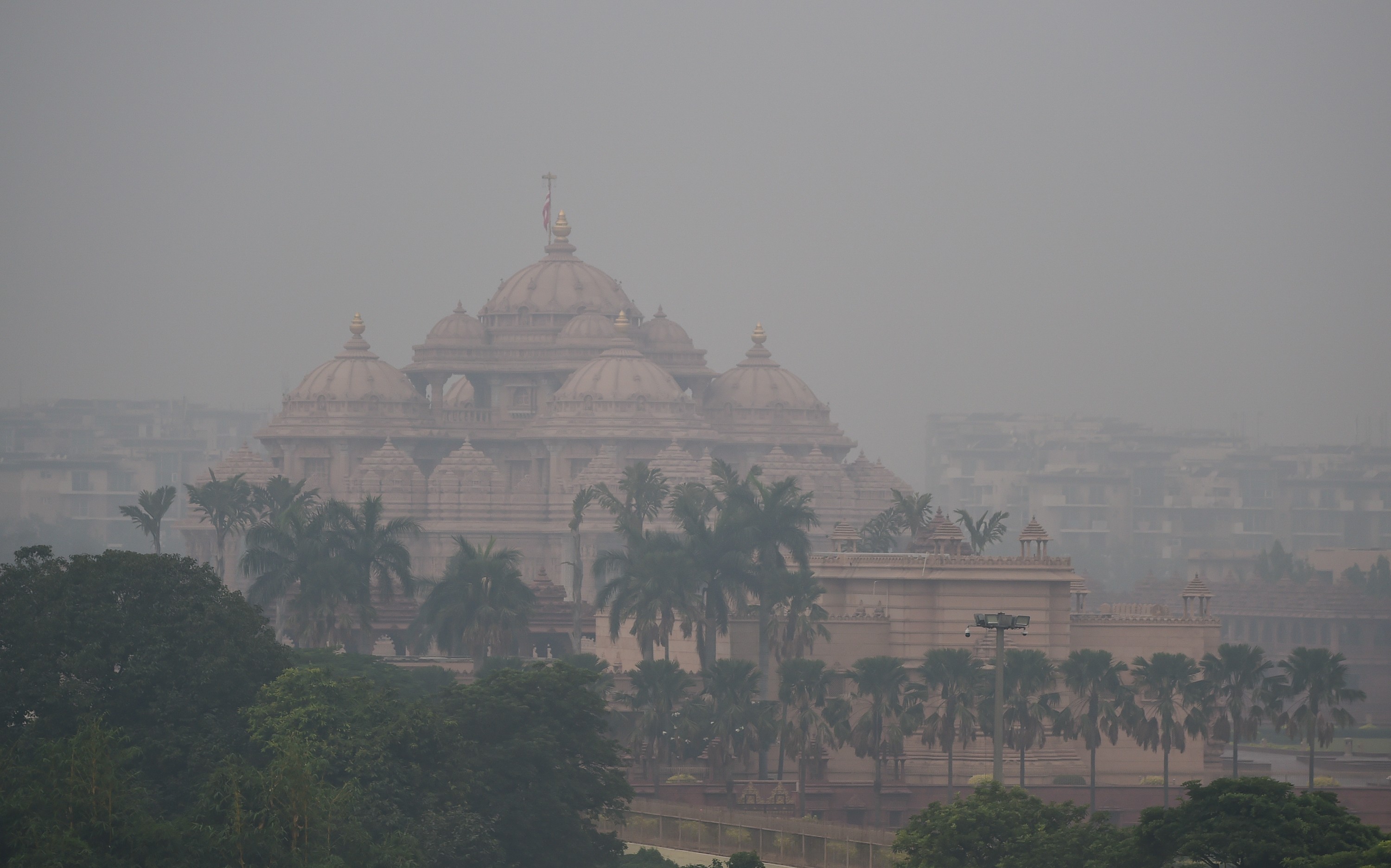 A view of a historic temple and its grounds in smoggy air