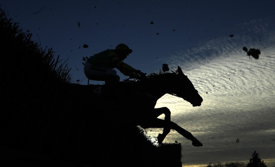 A rider on a horse leaps over an obstacle.