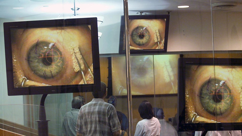 Closeups of an eye on several television monitors