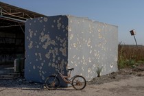 A photo of an abandoned bike in front of a shelter near the Nahal Oz kibbutz in Israel