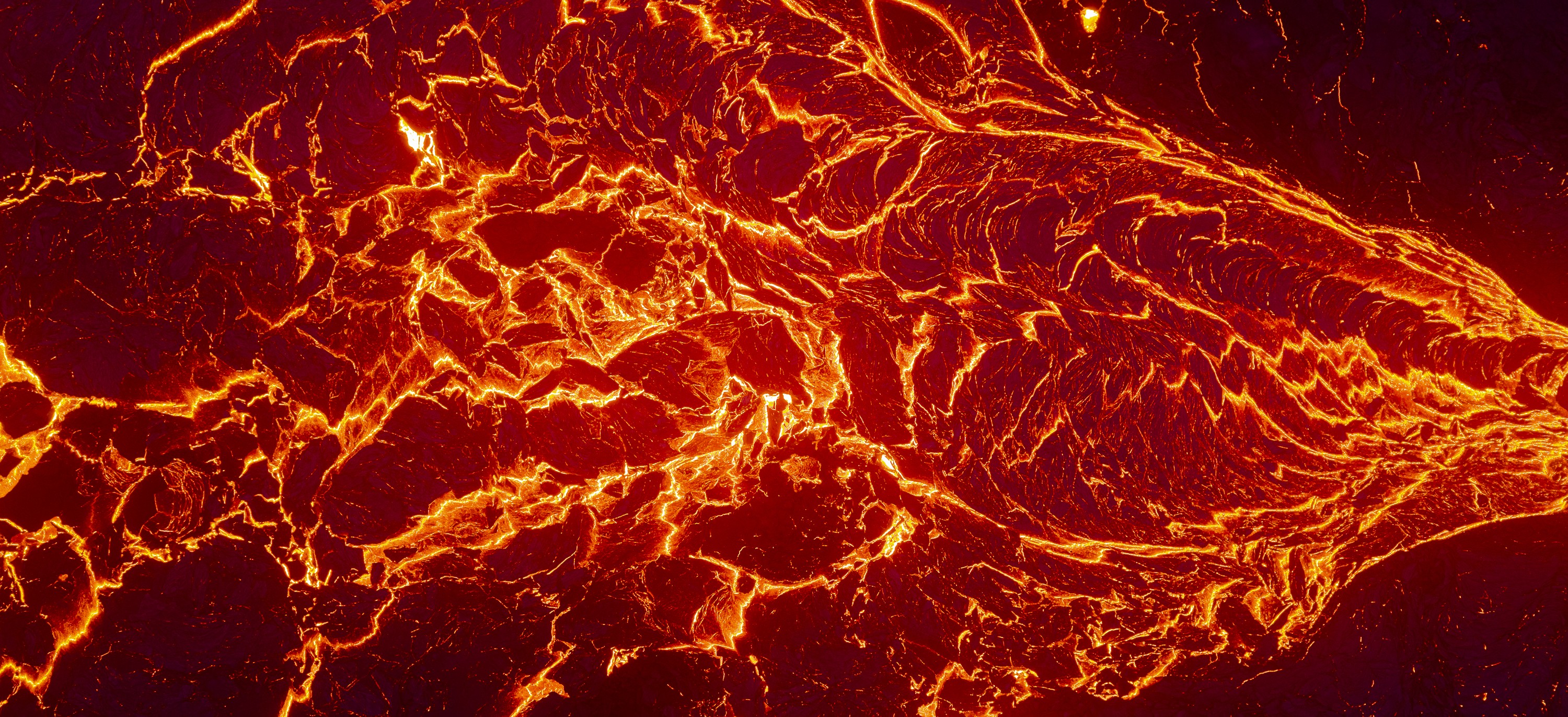 An aerial view, looking down at flowing lava