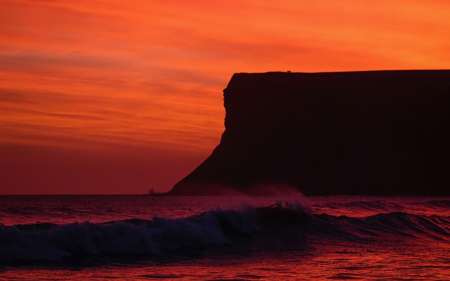 A dramatic morning sky rises behind Huntcliff as waves break on the beach on March 15, 2017 in Saltburn-by-the-Sea, England. 