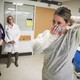 Kaylen Smith demonstrates how to don the protective gear that must be worn when dealing with patients with an infectious disease as Massachusetts General Hospital in Boston prepares for a possible surge in coronavirus patients.