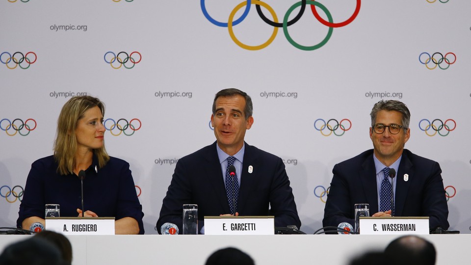 U.S. International Olympic Committee member Angela Ruggiero, L.A. Mayor Eric Garcetti, and Chairman of the L.A. 2024 Candidature Committee Casey Wasserman attend a briefing on July 11, 2017.