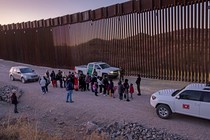 Border Patrol agents prepare to transport migrants.