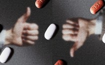 A hand making a thumbs-up and a hand making a thumbs-down behind a field of Paxlovid pills
