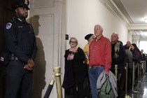 Members of the public wait in line hoping to get into the hearing room as former U.S. Ambassador to Ukraine Marie Yovanovitch arrives to testify.