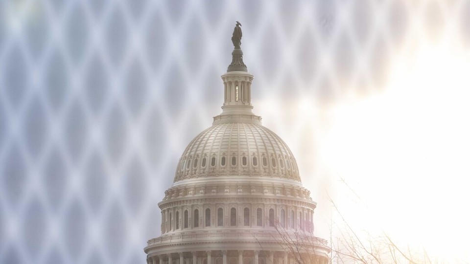 The U.S. Capitol behind a fence.