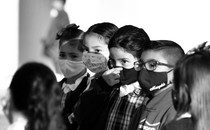 A row of children in face masks