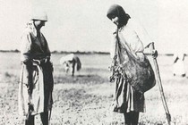 Two women standing with shovel