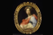 A blurred portrait in a gilded frame