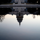 A photograph of the U.S. Capitol Building reflected upside down in the reflecting pool on the National Mall