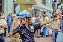 A photo of a motorcycle cop directing traffic outside Haymarket Square in Boston in 1979
