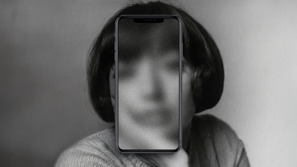 A black-and-white portrait of a woman with a phone over her face