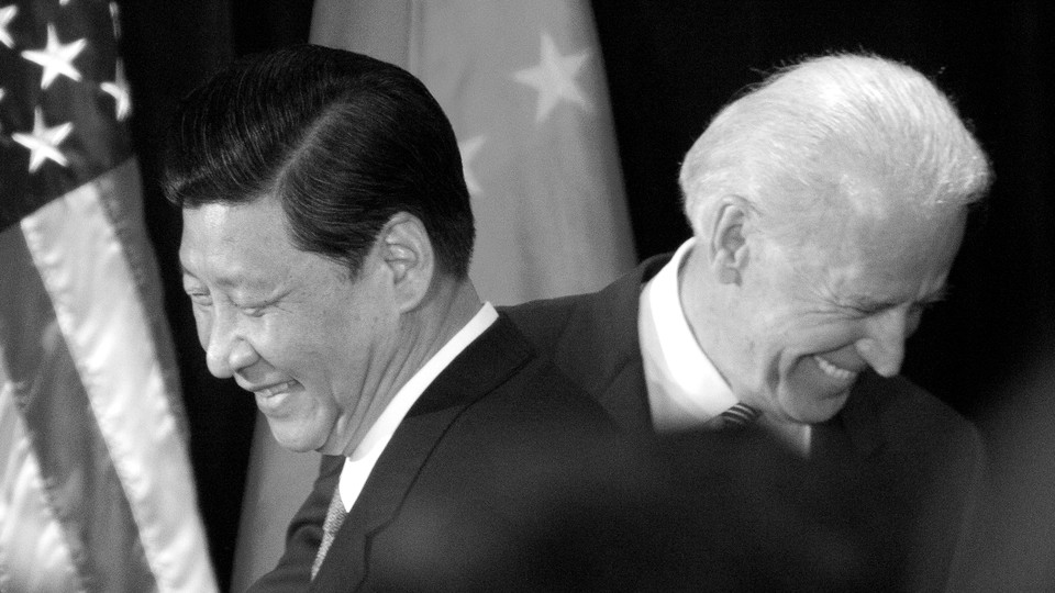 Joe Biden and Xi Jinping pass each other.