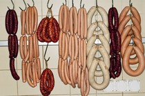 Sausages hang on meat hooks