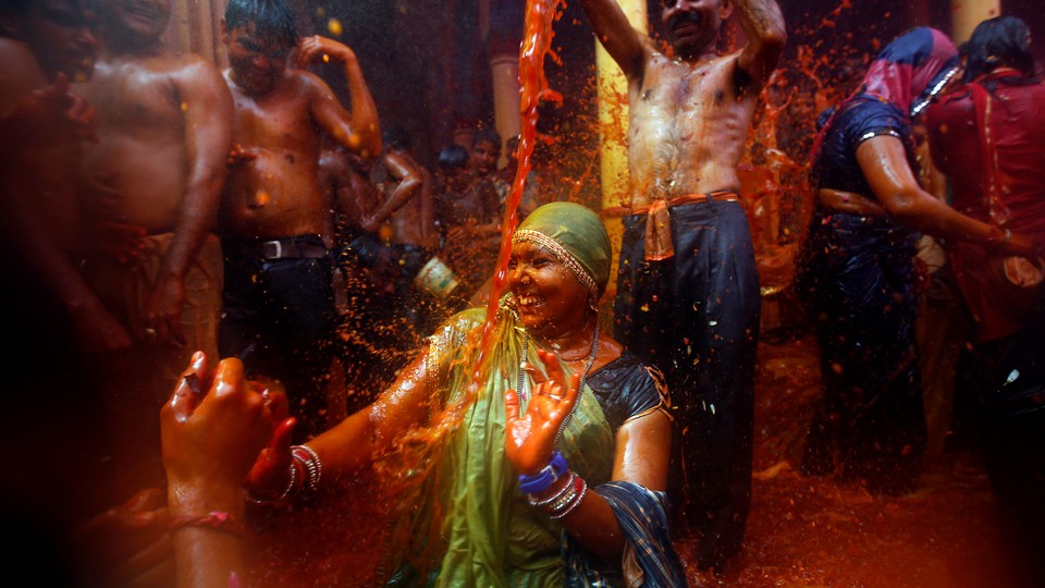 A man throws water on a woman during "Huranga," a game played between men and women a day after Holi, near Mathura, India.