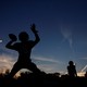 A silhouette of a high-school football player throwing a pass