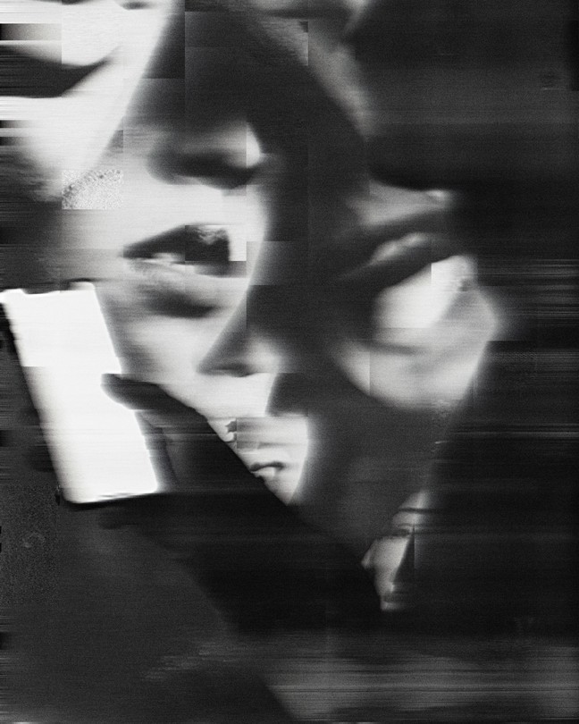 Black and white composite image of many faces superimposed behind a person holding a smartphone