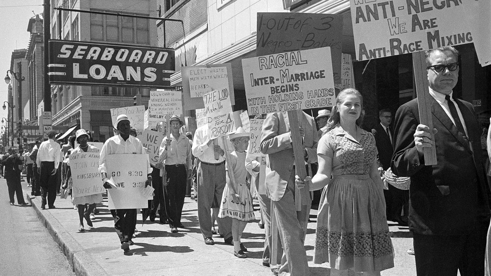 A group of black marchers protesting school-board policies is met by white counterprotesters during a double demonstration in Memphis on August 31, 1963.