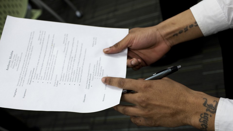 A man recently released from prison held his résumé at a mock job interview during a job-training program at the Center for Urban Families in Baltimore.
