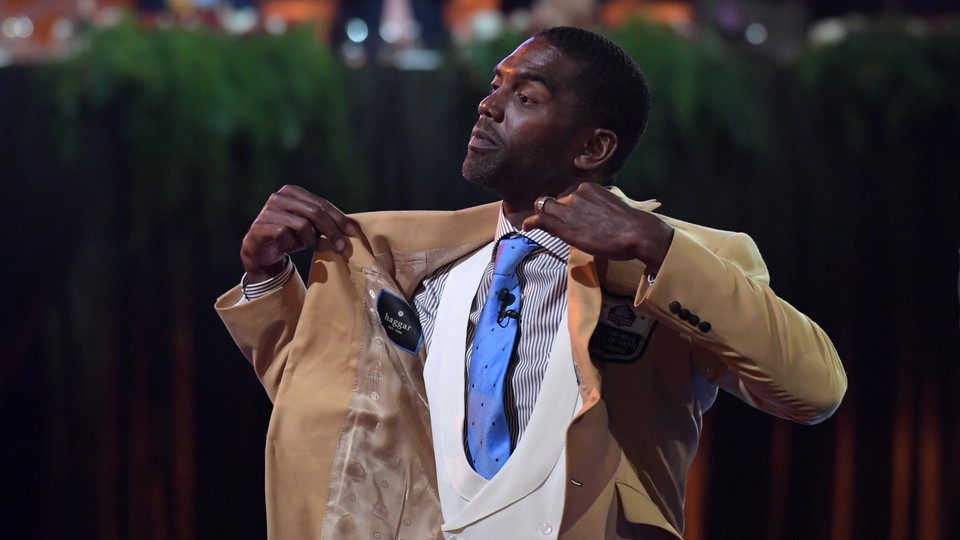 Randy Moss reacts after receiving a gold jacket during the enshrinee's gold-jacket dinner at the Canton Memorial Civic Center
