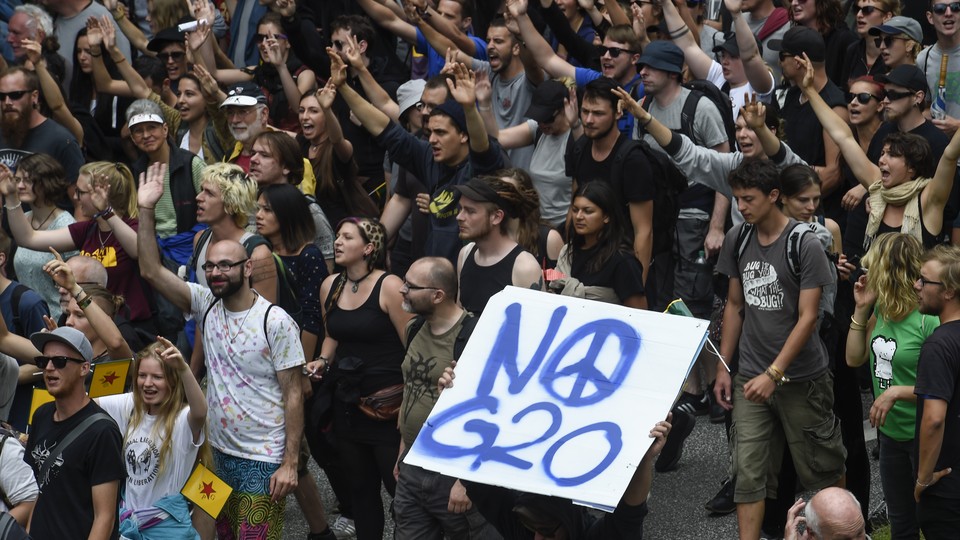 Protesters hold a placard that reads 'No G20' during demonstrations at the G20 summit in Hamburg, Germany.