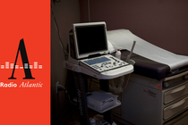 Photo of hospital examination table and monitor next to "Radio Atlantic" logo