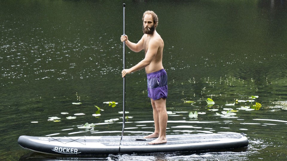 Ben Sinclair on a stand-up paddleboard in 'High Maintenance.'