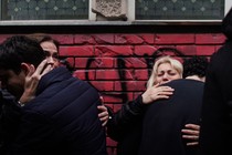 People react outside the Vladislav Ribnikar elementary school in Serbia's capital, Belgrade, on May 4, 2023, a day after a 13-year-old suspect shot dead eight fellow students and a security guard after allegedly drawing up a kill list