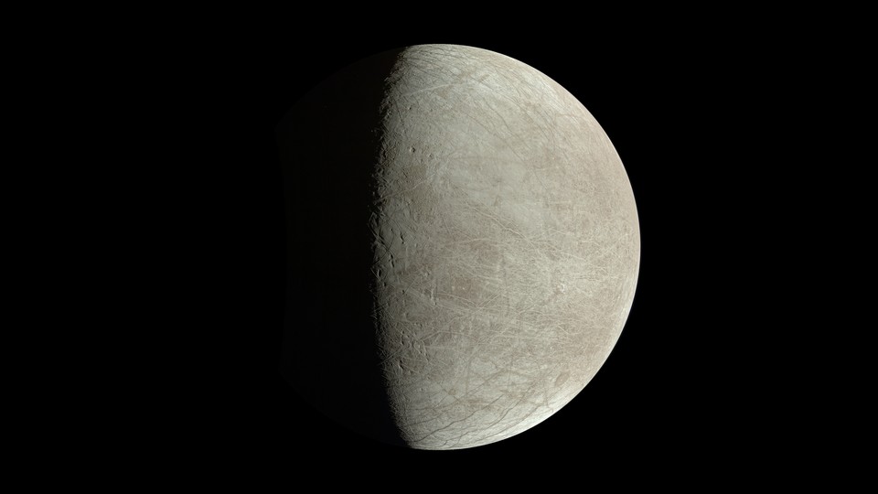 An image of Europa, Jupiter's icy moon, with one half illuminated