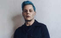 soft-focus photo of Jack White with blue hair and dark collared shirt
